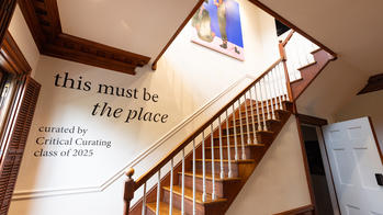 photo of show title and stairs leading up to gallery