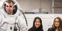 HI-SEAS crew member Andrzej Stewart tries on a modular space suit designed by students Erica Kim 18 AP/ID and Kasia Matlak MID 17