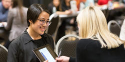 Student reviewing portfolio with a design professional at Design Portfolio Review