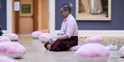 2019 Dorner Prize winner, Nathan Wong 19 PR, performs a silent piece in honor of the RISD Museum’s ancient Buddha sculpture