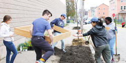 Students work with local organizations to install three large-capacity wooden planters in Providence’s Trinity Square
