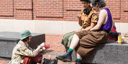 Students sit outside in Market Square, on RISD's campus.