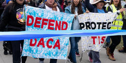 Protesters with signs supporting Deferred Action for Childhood Arrivals
