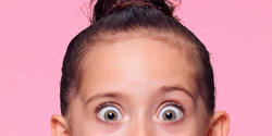 Close-up of wide-eyed little girl's face