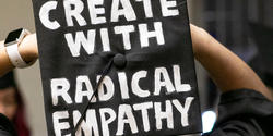 Graduation cap with "Create with radical empathy" painted on it