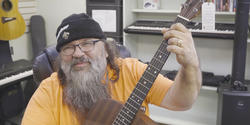 A blues musician playing guitar