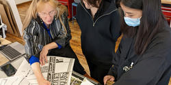 Professor Anne Tate confers with students