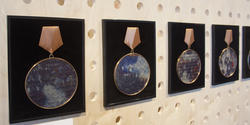 Three medallions on display at a SNAG exhibition by Ying Valerie Ho
