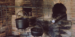 image of blackened pots on an old hearth