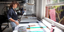 a student works in front of an open window