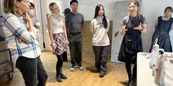 Lesley Baker and students consider work by Dora Chen
