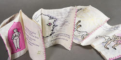 A hand-embroidered acordian book made of fabric and painted with watercolor by Ashely Castañeda