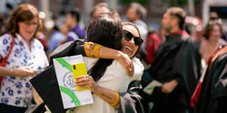 graduating students hug outside of the First Baptist Church, 2023