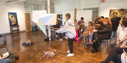 first-year student Emily Kwak takes a swing at her pinata during spring 2023 crits