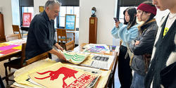 Students in Rene Payne's Be the Change Graphic Design course visit special collections to learn about RISD's archival history