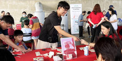 Joel Yong passes out information at a RED event