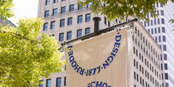 RISD flags flying in front of downtown highrises