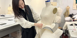 Sophomore Jaclyn Zhang sews a garment on a dress form