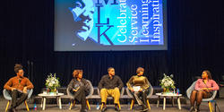 panelists on stage with an image of King behind them