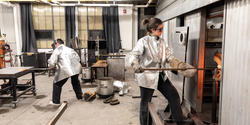 students work side by side in the hot shop