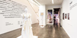 inside the Gelman Gallery with view of off-white cotton dress