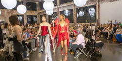 Sue Sima walks the runway hand in hand with a model