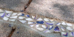 Crushed quahog shells artfully fill in a crack in the sidewalk