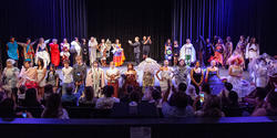 all of the student designers and models on stage for a last bow