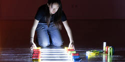 student uses colorful lights in solo performance piece