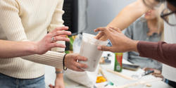 hands of several students testing the consistency of the mold they made