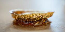 close-up view of amber-colored prototype filled with tiny bubbles