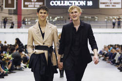 Lathrop walks the runway with one of his models at the end of the show