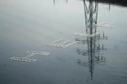 The word "Help" spelled out with floating objects on the water
