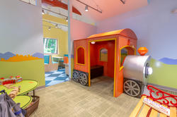 A train and related materials for children in an exhibit by Margaret Middleton 08 ID that focuses on creating inclusive, accessible learning environments for children