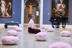 2019 Dorner Prize winner, Nathan Wong 19 PR, performs a silent piece in honor of the RISD Museum’s ancient Buddha sculpture