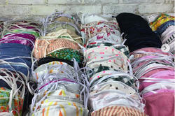 Many cloth face masks of different colors