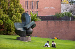 Students sitting/laying on RISD beach in downtown Providence, RI