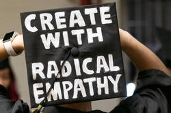 Graduation cap with "Create with radical empathy" painted on it