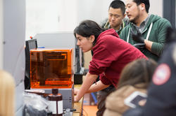 Student working with a 3D printer