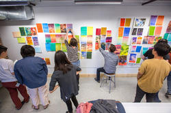a wide-angle view of students at an Illustration crit