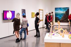 Museum visitors viewing mounted artworks