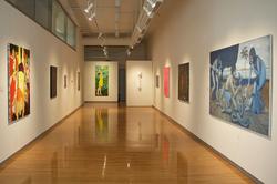 paintings lining exhibition walls on opposite sides of the Sol Koffler Gallery
