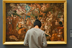 a student stands in front of a painting at the RISD Museum