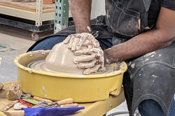 close-up shot of Baralaye's hands in the clay