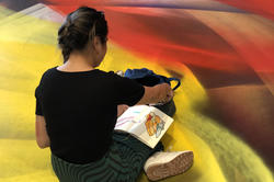 a woman sketching in an extremely colorful setting