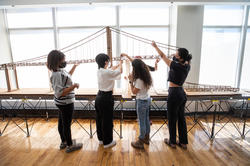 Group-of-students-constructing-bridge-model.