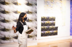 RISD textiles graduate student speaks to critics and fellow students during her final crit