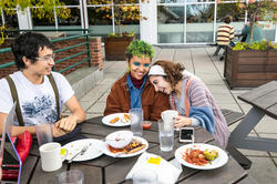 three risd students joyfully eat and hang out at the met cafe