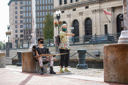 RISD professor giving direction to a student drawing outside