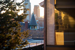 a view from the risd quad of greenery and the tip of carr haus